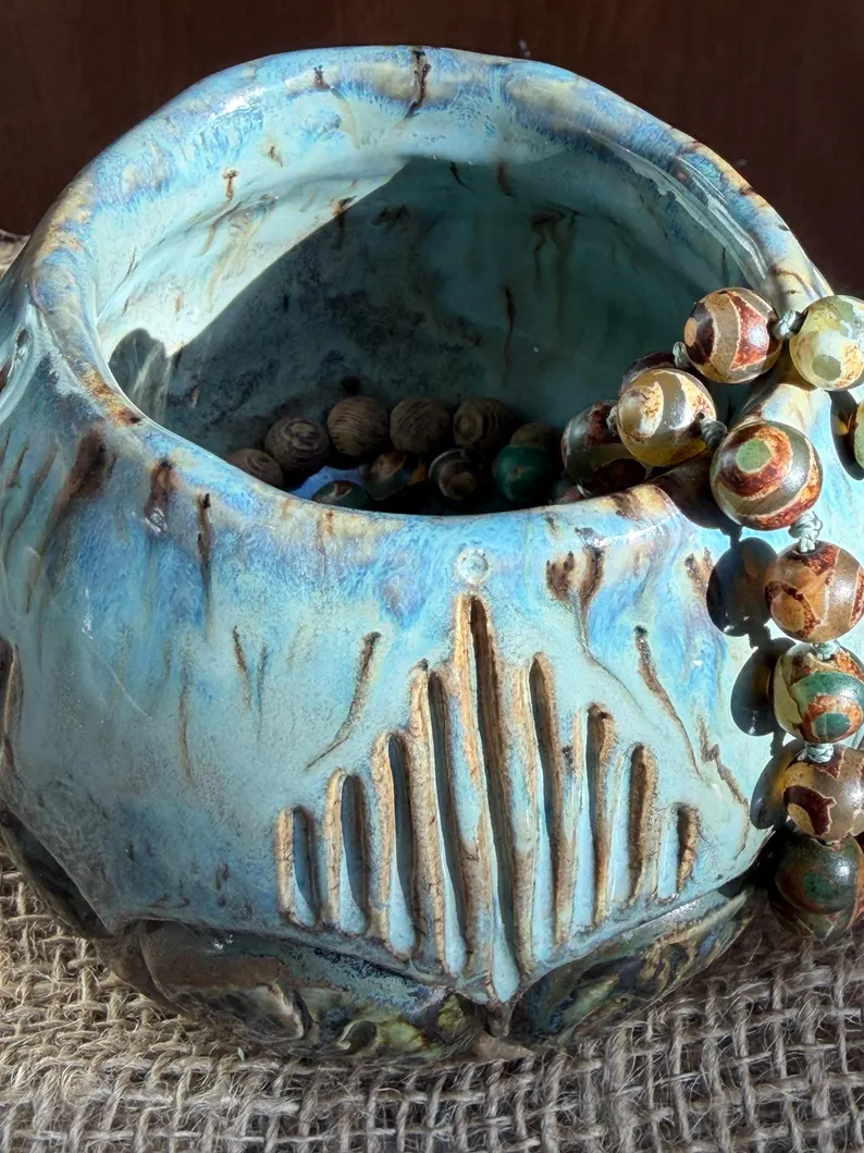 Small handmade blue ceramic pot with a carved botanical design by Jaymi